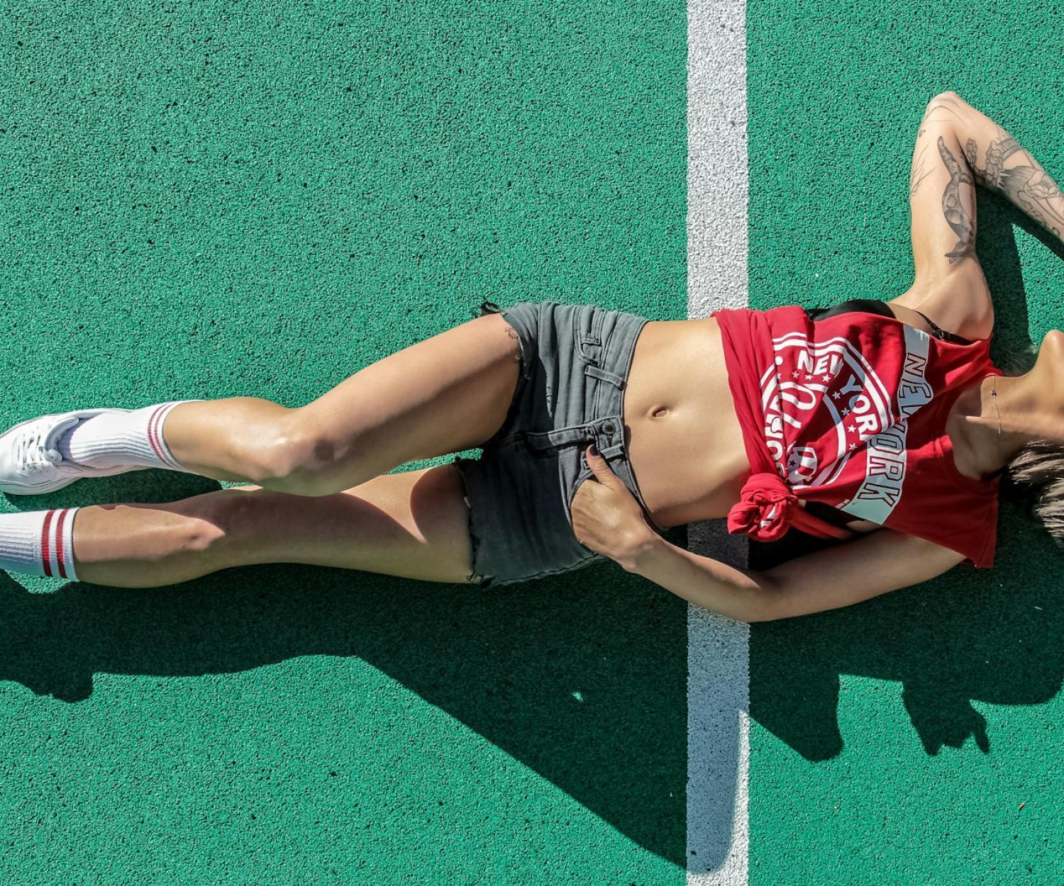 LEED woman lying on sports field