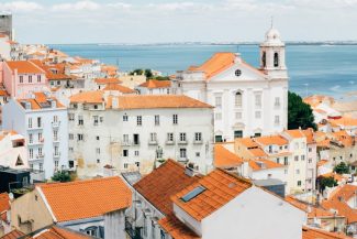 Healthy Buildings Lisbon - Lisbon's Green Shift: Demand Soars for WELL & LEED Certified Buildings Healthy Buildings Lisbon - landscape photography of orange roof houses near body of water