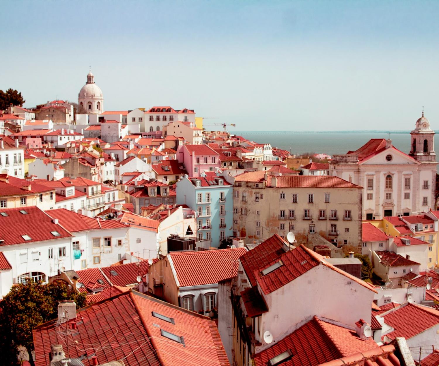 Healthy Buildings brown and white concrete houses near body of water during daytime