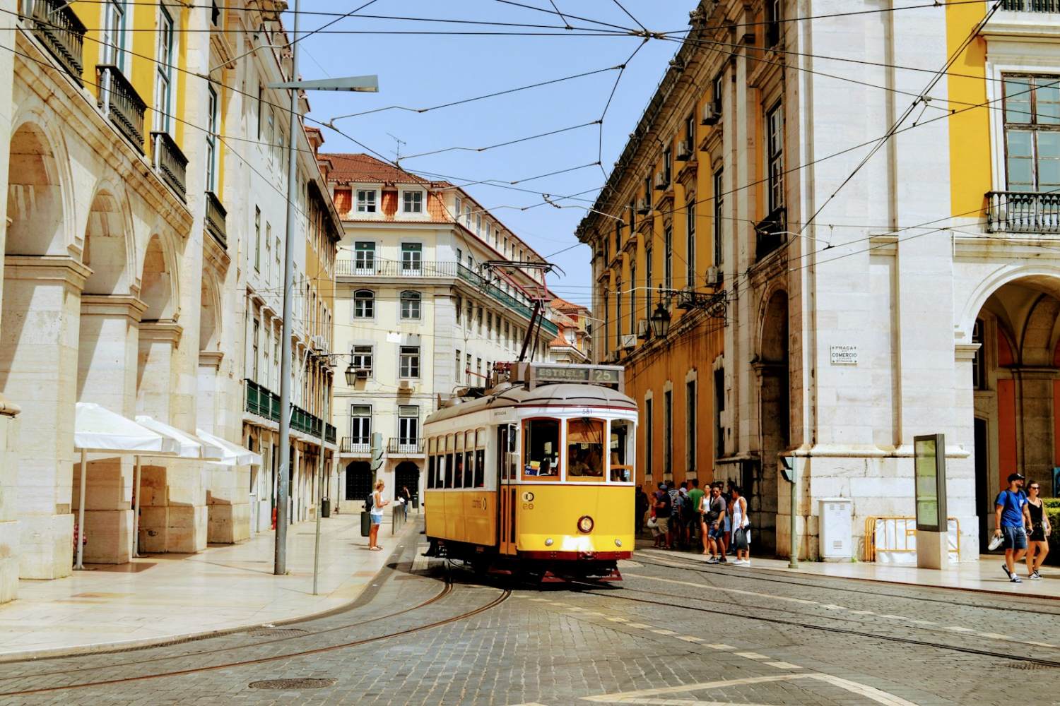 Lisbon yellow and white tram on road during daytime