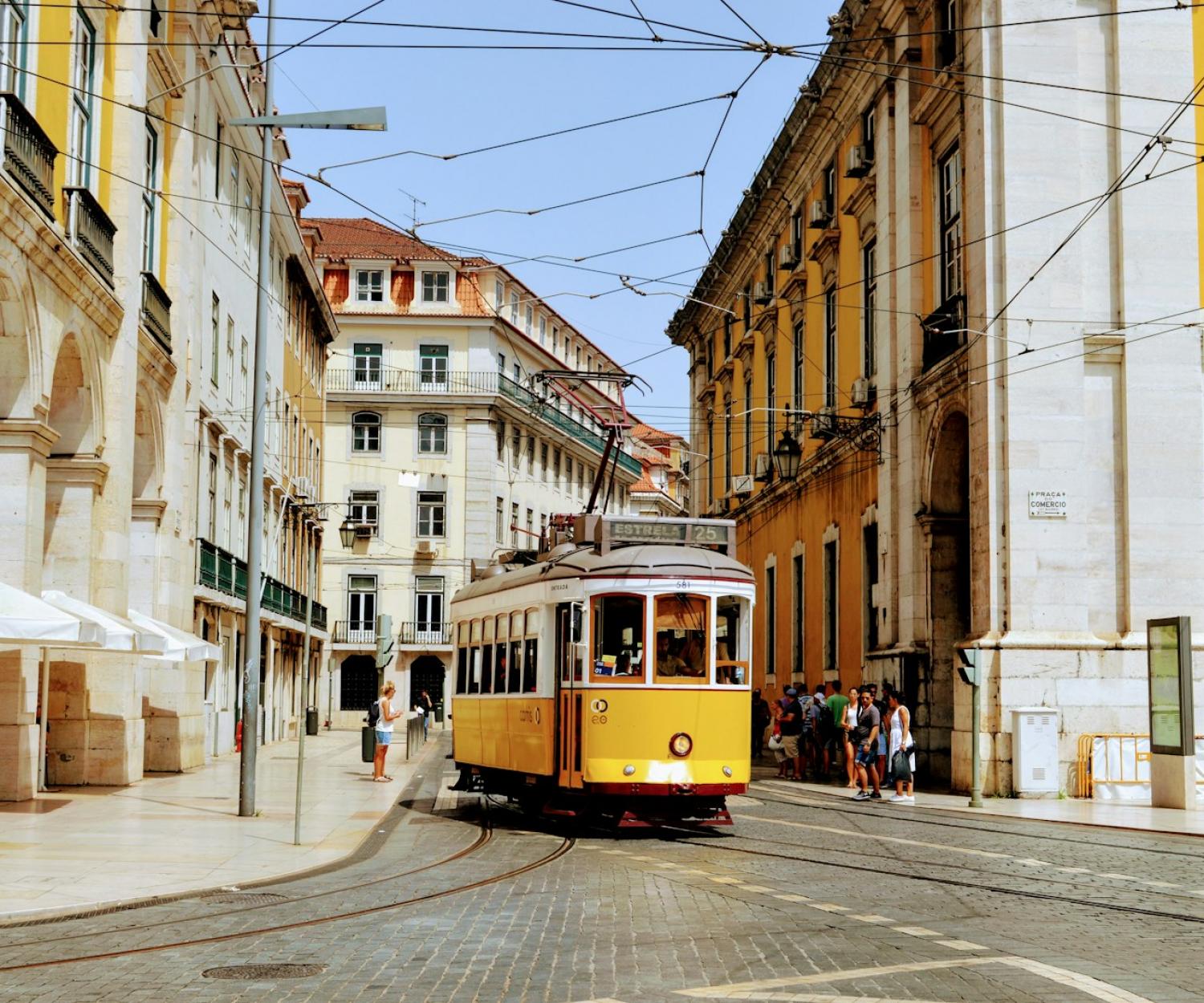 Lisbon yellow and white tram on road during daytime