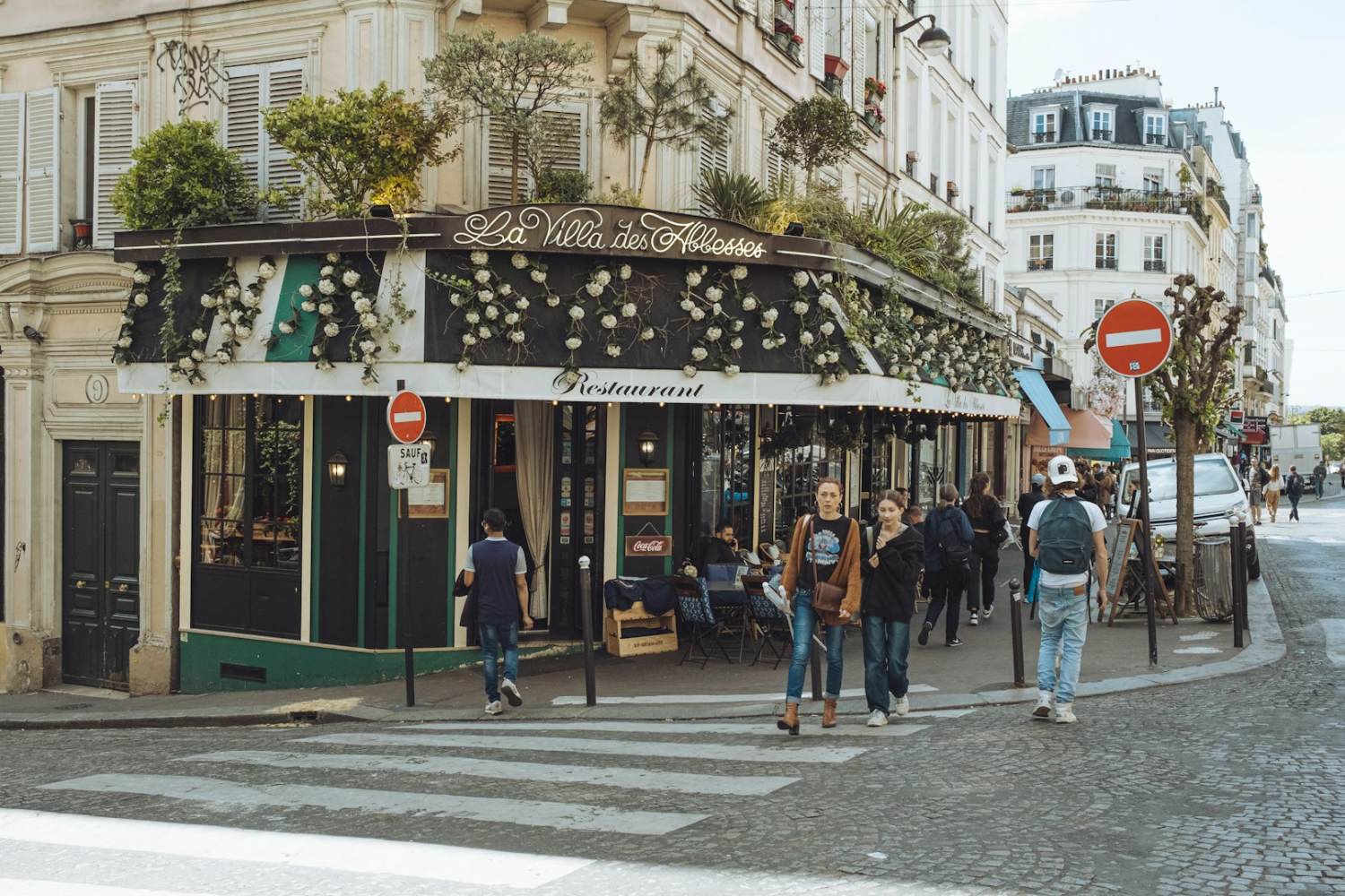 Sustainable Living Portugal a group of people walking down a street next to tall buildings