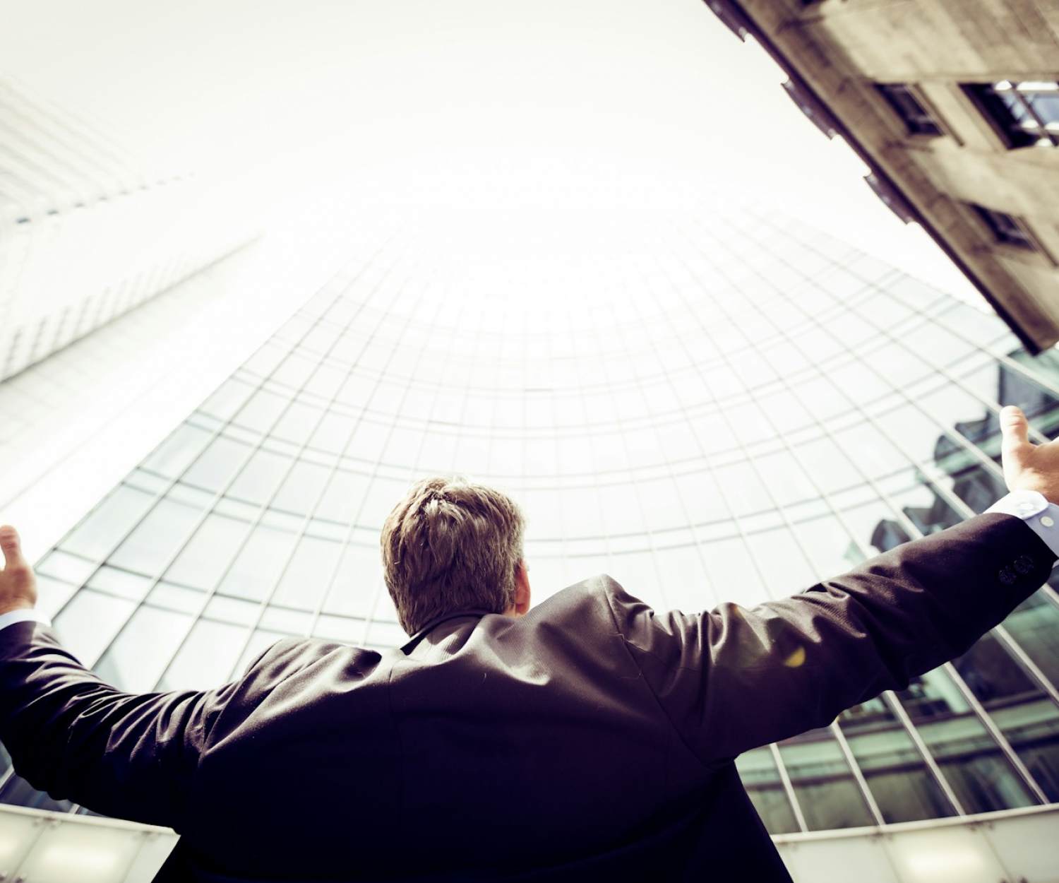 Sustainable Consulting Portugal. low-angle photography of man in the middle of buidligns